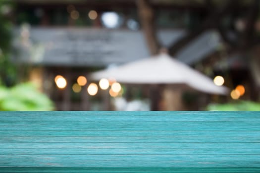 Top of blue wooden table with cafe blurred abstract background