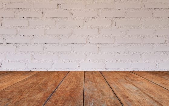 Wooden table top with brick wall decorated in coffee shop