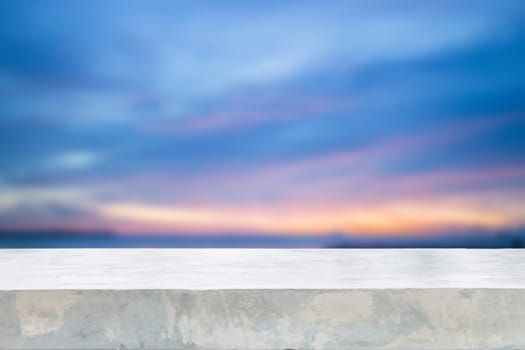 Concrete table top with sunset abstract blur background, stock photo