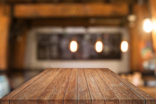 Perspective wooden table top with coffee shop blurred abstract background