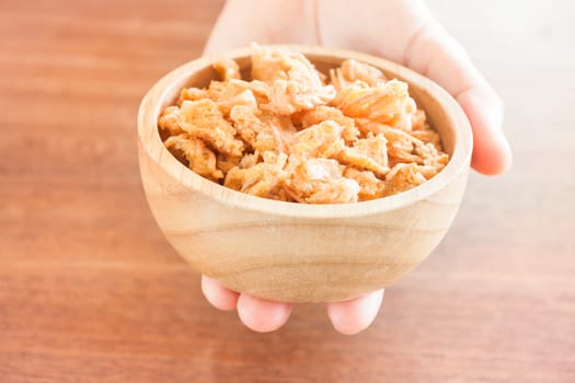 Fried shrimp chins snack in wooden bowl, stock photo