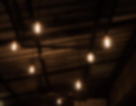Warm lighting lamps on ceiling in coffee shop, stock photo