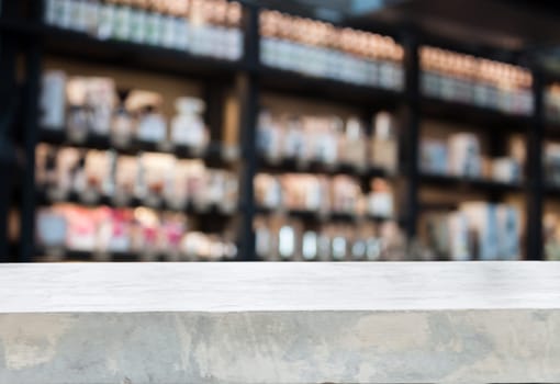 Concrete tabletop with coffee shop blurred background with bokeh