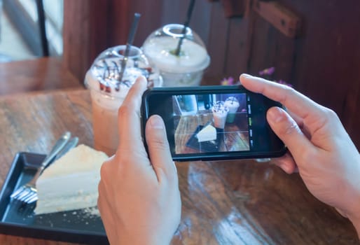 Closeup woman using smartphone in coffee shop, stock photo
