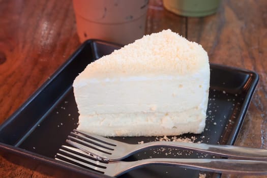 Closeup cheese cake on black plate, stock photo