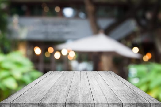 Perspective black and white wooden table top with cafe blurred abstract background