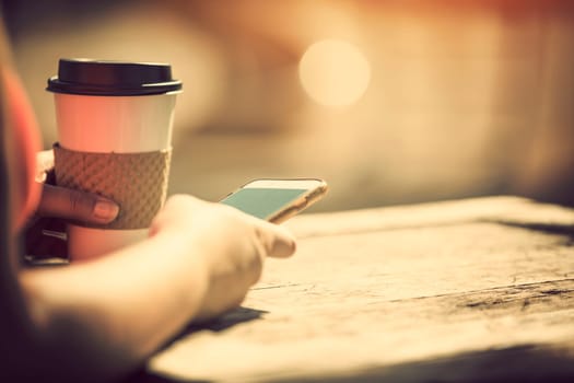Woman holding smart phone outdoors