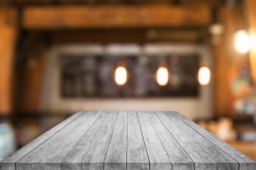 Perspective black and white wooden table top with coffee shop blurred abstract background
