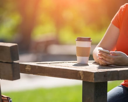 Woman holding smart phone outdoors