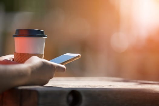 Woman holding smart phone outdoors