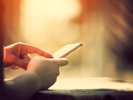 Woman holding smart phone outdoors