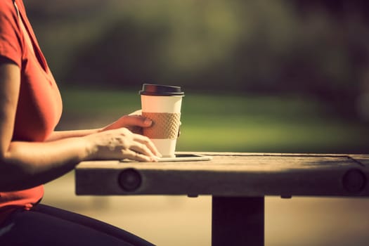 Woman holding smart phone outdoors