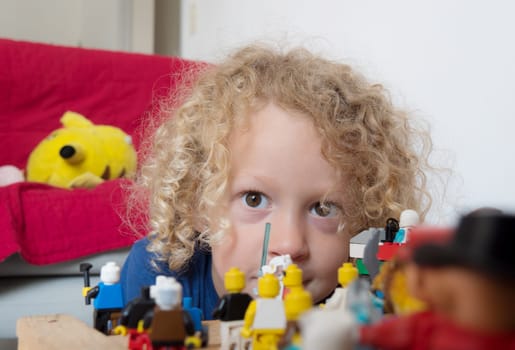 a little blond boy and his toys