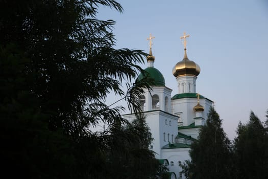 Evening view of the white-stone church near park