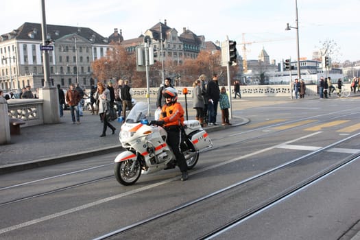 Zurich, Switzerland - November 26, 2011. A police officer on a motorcycle accompanying the demo