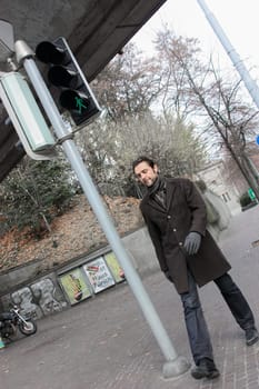 Zurich, Switzerland - November 26, 2011. A pedestrian is going to cross the road on a green traffic light signal