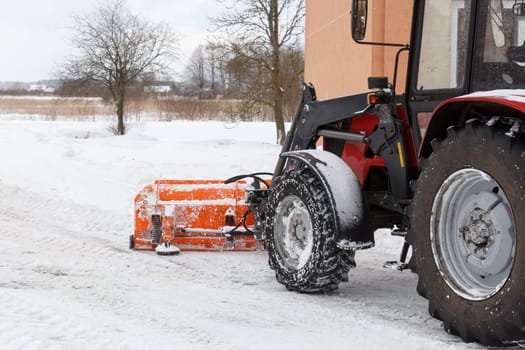 A tractor cleaning snow off from the road