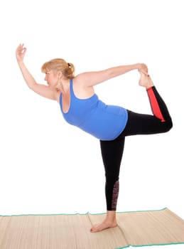 A lovely blond woman is yoga outfit standing on a mat, showing some .poses for yoga exercises, isolated for white background..