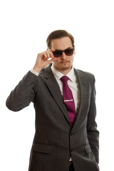 a young man in a suit with sunglasses