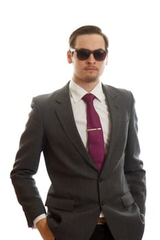 A young adult in a fancy suit with sunglasses