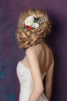 Styling hair with flowers. Portrait of the bride. Hairstyle.