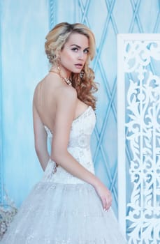Luxury. Glamour woman with blonde curly hair and bright makeup.