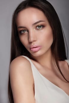Make-up & cosmetics. Portrait of beautiful woman model face with clean skin, full glossy lips.
