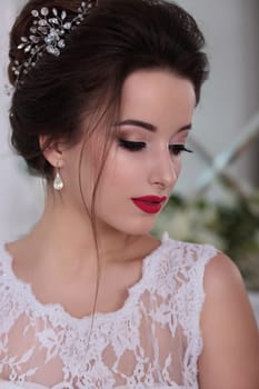 Bride portrait. Wedding makeup, red lips. Clip in hair.