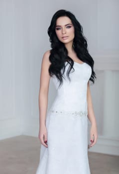 Bride with long hair. Portrait in the interior.