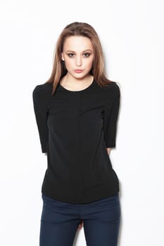 Young female model posing in the studio, fashion, looking into the camera.
