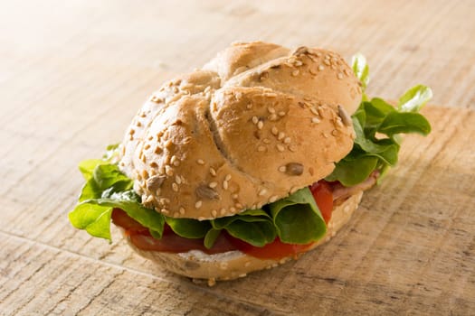 Sandwich with fresh smoked meat, cheese, lettuce and tomato with homemade ketchup