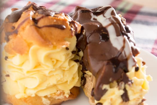 Cream Pie. Two layers of puff pastry filled with whipped cream decorated with melted chocolate on a white plate