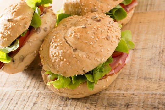Sandwiches with fresh smoked meat, cheese, lettuce and tomato with homemade ketchup