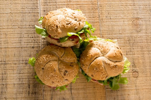 Sandwiches with fresh smoked meat, cheese, lettuce and tomato with homemade ketchup