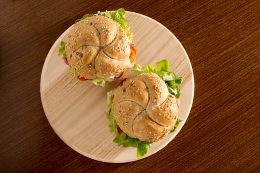 Sandwiches with fresh smoked meat, cheese, lettuce and tomato with homemade ketchup