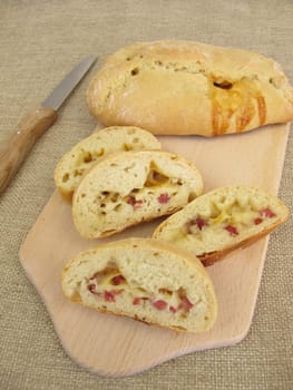 Stuffed pizza bun with cheese and ham