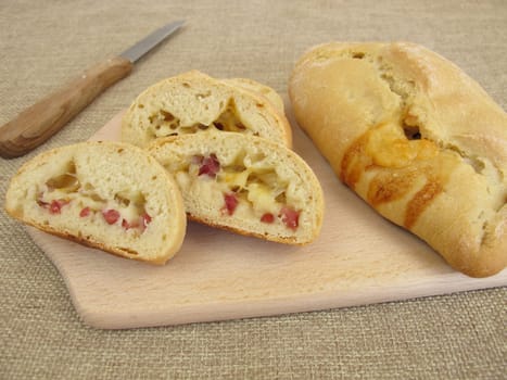 Stuffed pizza bun with cheese and ham