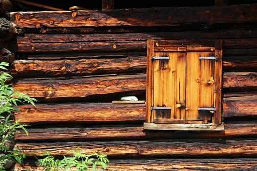 Closed window with shutters on an old farmhouse