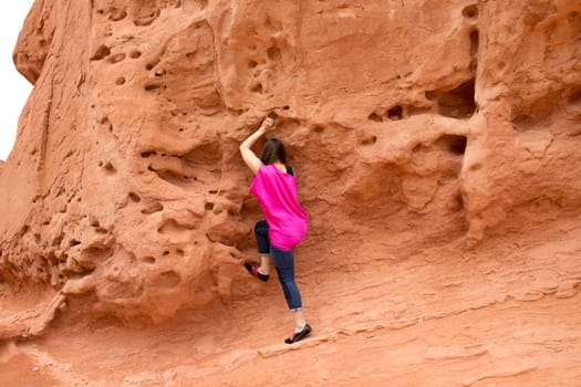 The young woman at Valley of Fire State Park, USA. The Valley of Fire State Park is the oldest state park in Nevada, USA and was designated as a National Natural Landmark in 1968.