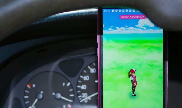 Dnipro, Ukraine - July 23, 2016: An Android user plays Pokemon Go in a car, a free-to-play augmented reality mobile game developed by Niantic for iOS and Android devices.