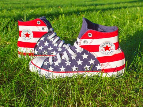 Dnipropetrovsk, Ukraine - August, 21 2016: All Star Converse sneakers on green grass in park