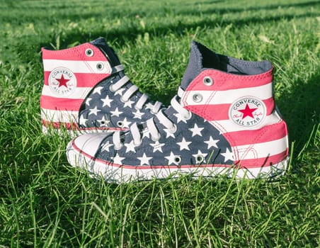 Dnipropetrovsk, Ukraine - August, 21 2016: All Star Converse sneakers on green grass in park