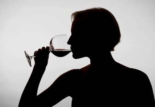 Woman drinks red wine