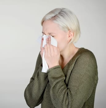 Woman sneezes