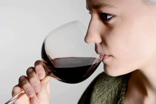 Woman drinks red wine