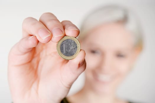 Woman holds one euro