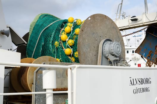 big fishing boat in the harbour with a big net ready to catch the fish