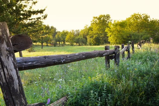 Old rural wooden fence on beauty landscape view
