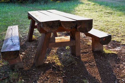 Picnic place in forest Wooden table with wooden bench