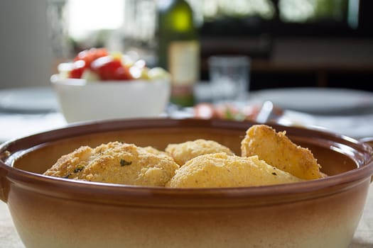 Breaded potato fried in the dish. Blurred background